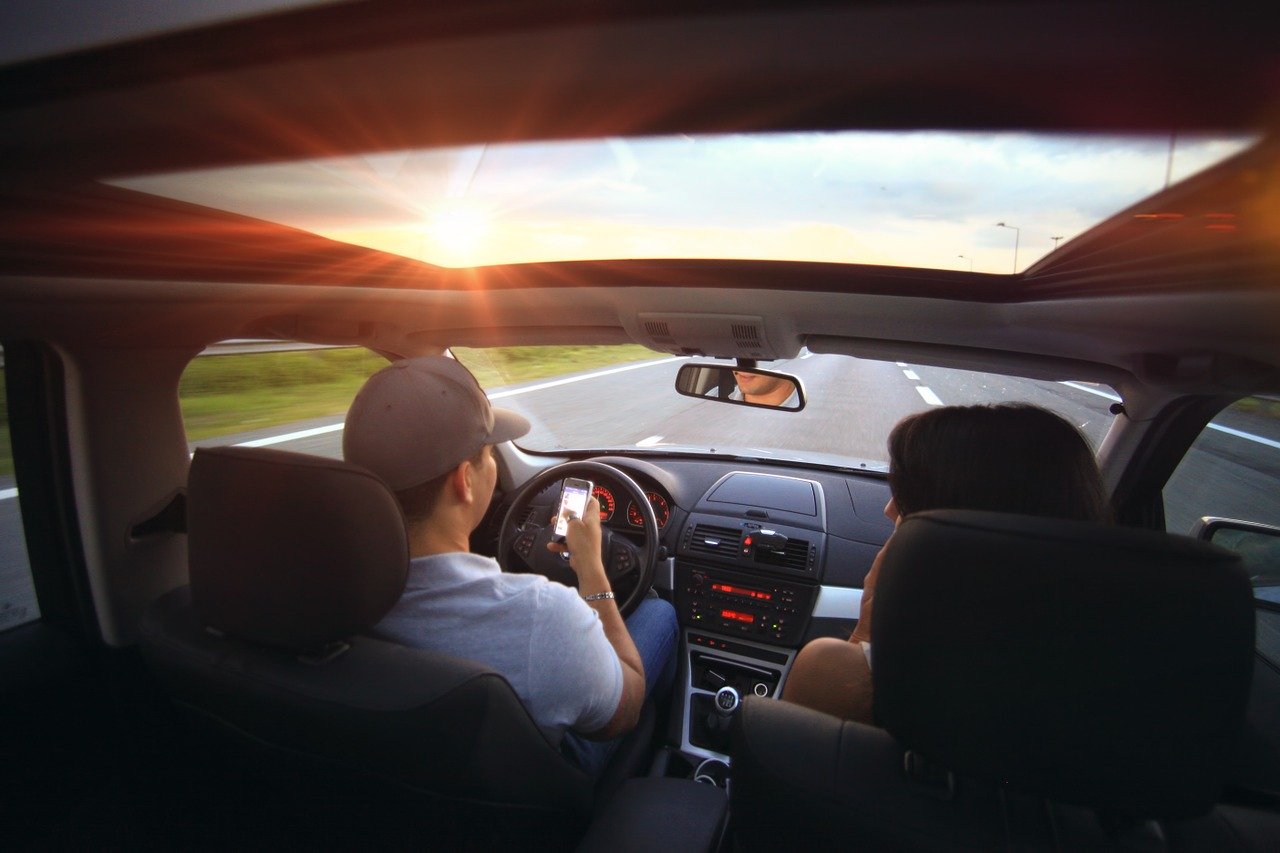 mand and womanvdriving with roof open